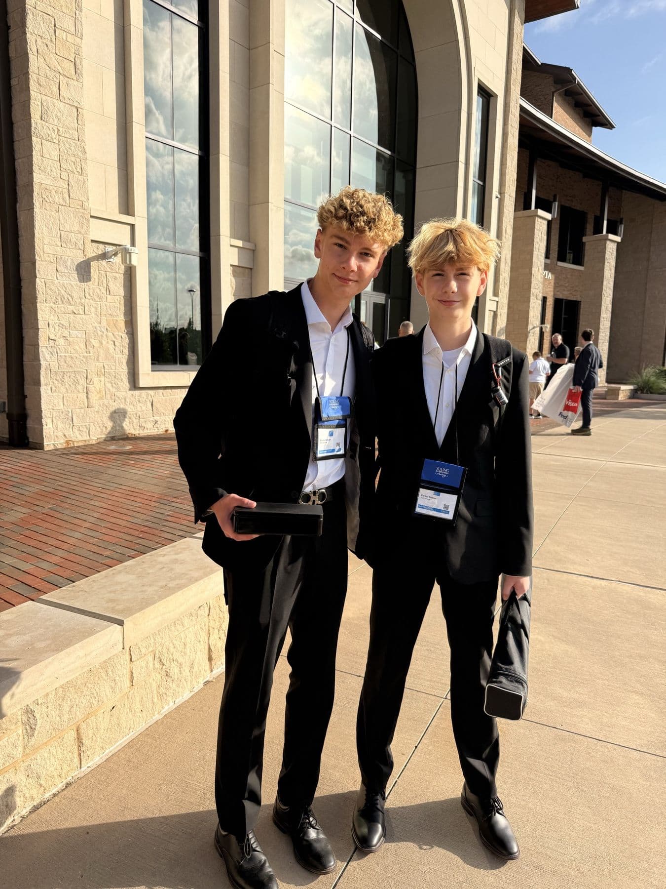Brady and Parker in suits on competition day in Frisco